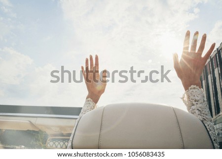 Bridal hands on the sunny sky background