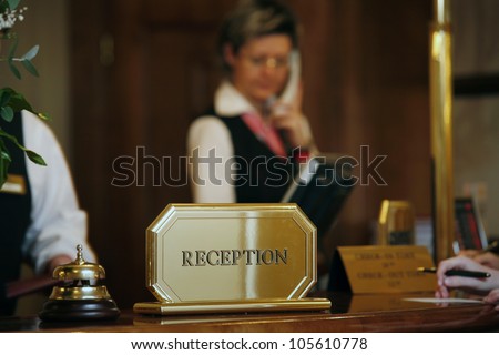 luxurious reception area with receptionist phoning