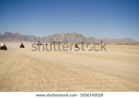 ourists on Quad bikes in the desert and mountains