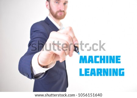 The businessman writes a blue marker inscription:MACHINE LEARNING