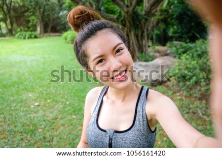 Portrait of smiling beautiful asian sport woman, happyness selfie take a photo