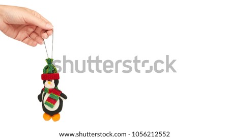 penguin Cristmas decoration in hand isolated on white background. New Year object. copy space, template.