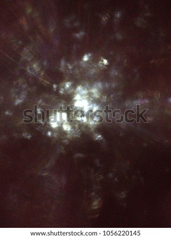 Black sky and Bokeh background. Sunlight over forest tunnel abstract. Halloween concept.