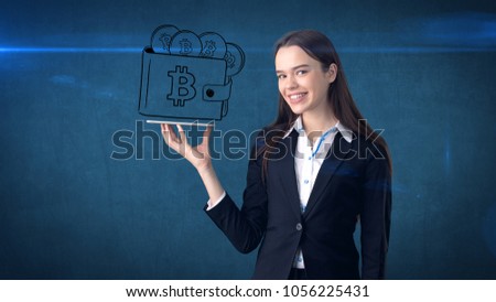 Beauty business woman standing near btc logo. Succesful Bitcoin investment. Concept of virtual criptocurrency.