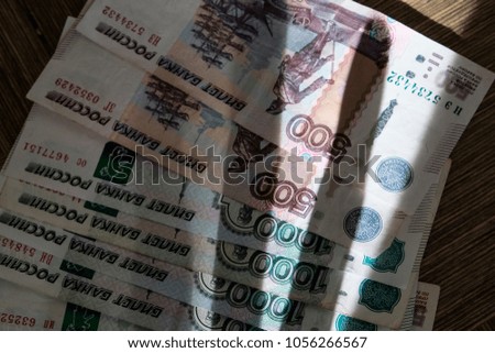 Cash Russian money 1000 and 500 rubles and a shadow by hand. shadow economy.
