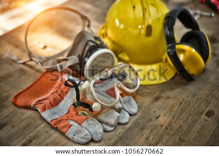 Standard construction safety equipment on wooden table. top view High Dynamic Range tone Royalty-Free Stock Photo #1056270662