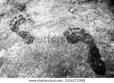 Abstract texture of footprints on the concrete floor. Black and white background for wallpaper