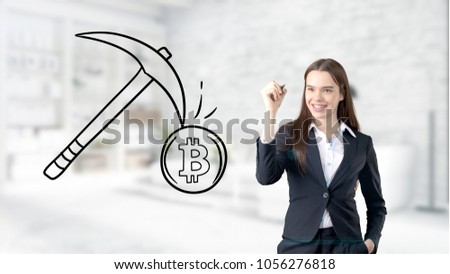 Surprised smiling young woman wearing a suit and looking at a cryptocurrency sketch on a design flat wall. Concept of Bitcoin risk.