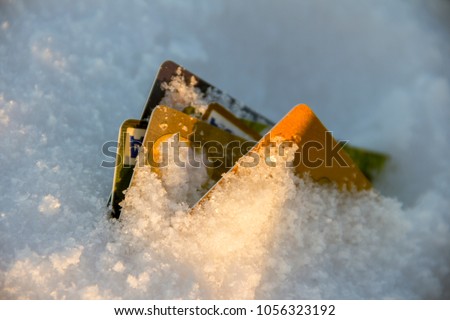 Frozen Bank Account Concept photo. Credit Cards buried in snow.