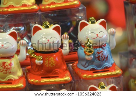 Welcoming cat oriental souvenir on sale in oriental fair Turin Italy March 25 2018 Wealth Lucky Waving Kitty Maneki Neko