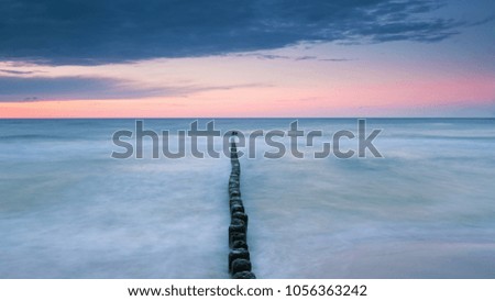 Wooden breakwater on the Baltic sea at dusk