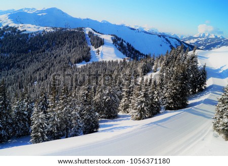 A pristine, empty freshly groomed ski slope on a picture-perfect day the in Austrian alps. A skier’s dream to ski in such perfect conditions. Location: Schmittenhöhe mountain, Zell am See Austria. 