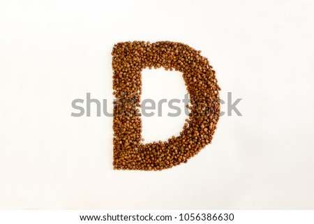 D the letter. alphabet of buckwheat porridge. buckwheat grain. concept of healthy eating. photo for your design. horizontal orientation of the sheet