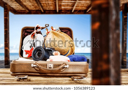 summer time and suitcase on wooden table
