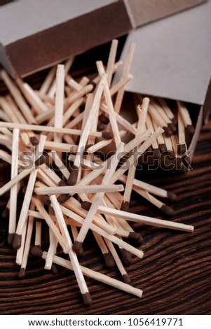 Matches in open match box on wood background