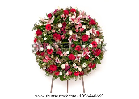 Funeral wreath isolated on a white background. Lilies and roses.