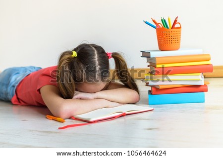 Difficulties in study. The tired child doesn't want to study. A stress in training Royalty-Free Stock Photo #1056464624