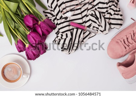Stylish feminine essentials, coffee and purple tulips. Spring flat lay.