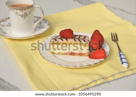 afternoon tea with cream cake on white marble table