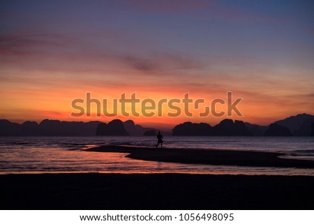 Silhouette picture of a man excercising in the morning agaist the background of beautiful sunrise at Yao Noi island, Phang-Nga province, Thailand