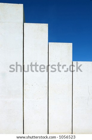 Concrete stairs shaped as chart on blue sky background