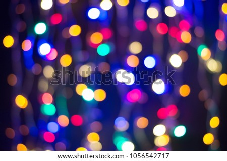Bokeh lights background, curtain of Christmas fairy lights. Abstract holiday lights defocused.