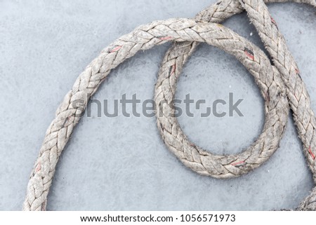 The abstract brightness photo showing of vintage big dirty rope messed up on the floor for texture and background