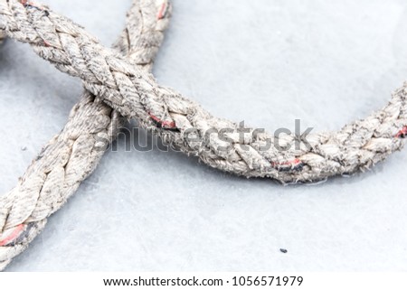 The abstract brightness photo showing of vintage big dirty rope messed up on the floor for texture and background