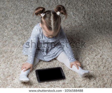 A little girl with the tablet