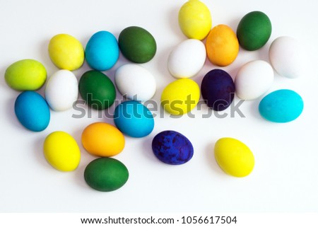 Easter festive colorful eggs on a white background. eggs yellow, blue, green and blue, orange and violet