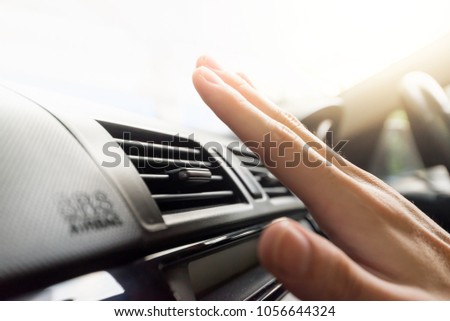 Closeup of hand checking the air conditioner in the car, The cooling system in the car Royalty-Free Stock Photo #1056644324