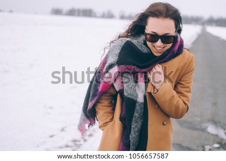 Portrait of a girl in sunglasses close-up, the girl is walking down the road looking down