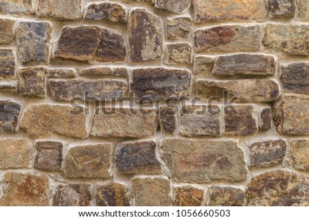 Fragment of a wall made of natural stone.