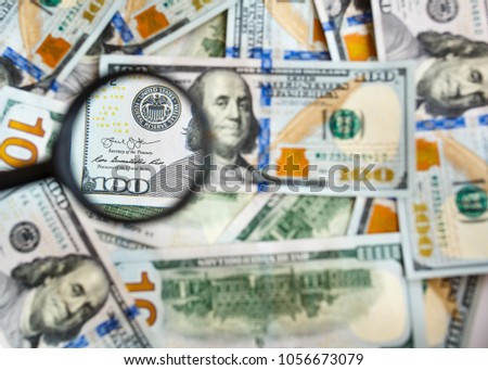 100 US dollars, background, signature under magnifying glass