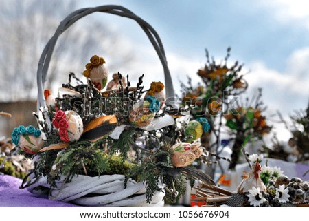 White Easter wicker basket. Bouquet with eggs, flowers and branches. 