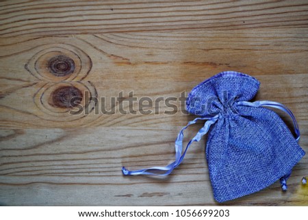 Postcard sample, blueberry gift pouch on wooden background with free copyspace for greeting text.