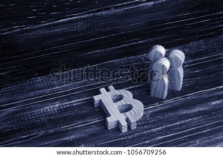 Wooden figures of people are standing near a bitcoin on a black background. Crypto currency, blockchain technology. The collapse and rise cost of bitcoin. Mining farms, miners, stock exchange crypts