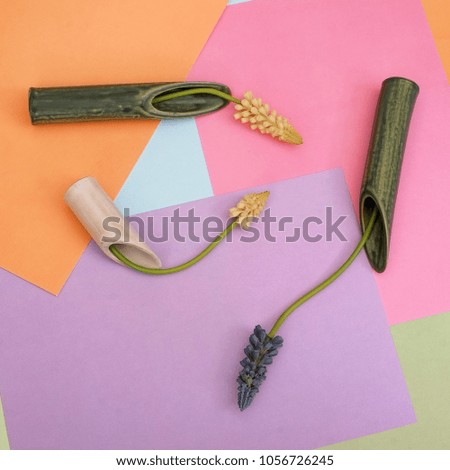 Composition with artificial flower isolated on a multi-colored background	