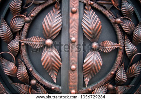SForged leaves from metal elements on beautiful metal gates