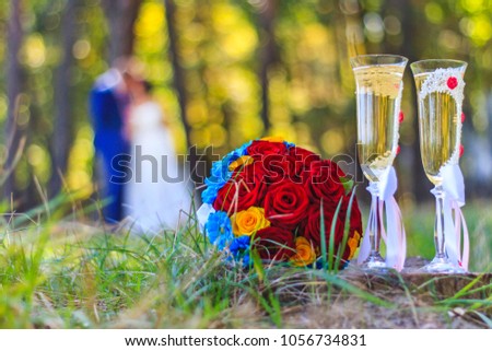 wedding picture, goblets and bouquet and newlyweds