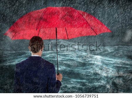 Digital composite of Back of business woman with umbrella in rain against stormy sea