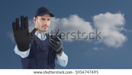 Digital composite of Security guard using radio while showing stop gesture against sky