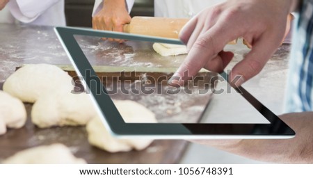 Digital composite of Hand taking picture of dough with tablet PC in bakery