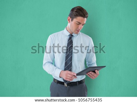 Digital composite of Businessman using digital tablet against green background