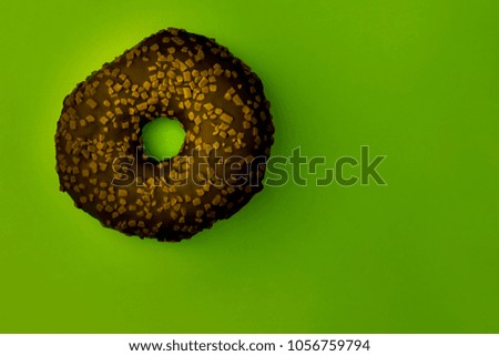 Puchy  chocolate donut on pastel green background