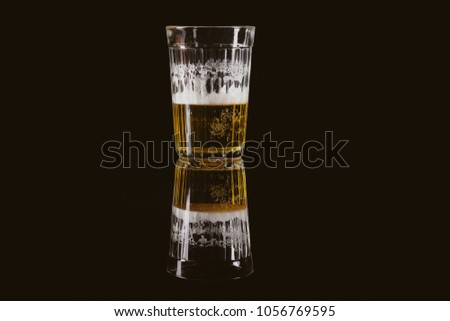 Faceted beer glass on a black background. Silhouette of a white beer mug lines on a black background. A glass of beer on a black background. vintage photo processing
