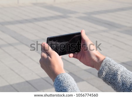 A smartphone is in the hands of a woman. Communication using a smartphone.