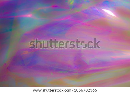 Holographic background. Light reflection, rainbow colors, psuchedelic pattern. Magical marbling and iridescent effect for banner templates and wallpapers. Pink shades