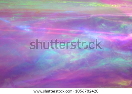 Holographic background. Light reflection, rainbow colors, psuchedelic pattern. Magical marbling and iridescent effect for banner templates and wallpapers. Pink shades