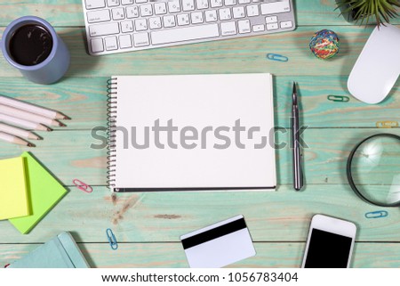 Office desk table with laptop, pen and notebook. Top view with copy space. Online shopping concept.